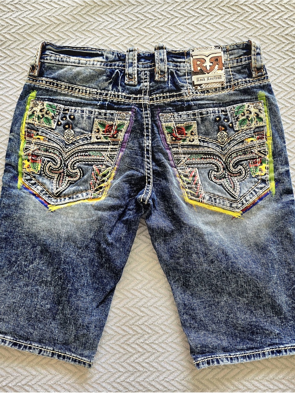 Rock Revival Blue Denim Shorts with Colorful Embroidered Pockets.